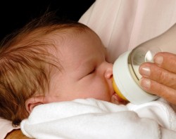 bottle feeding a baby