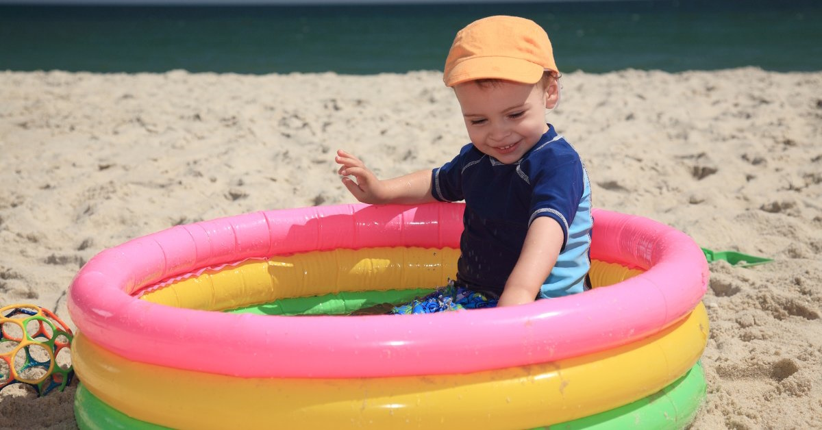 toddler in pool at the beach